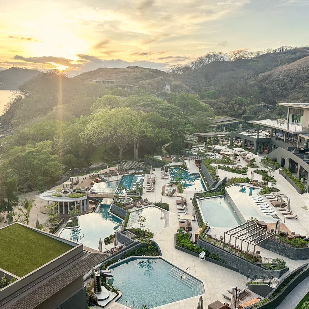 The terraced pools of the Waldorf Astoria Costa Rica Punta Cacique above the bay, low sun